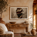 Living room with rustic decor, including a wooden console table, framed abstract art, and natural elements.