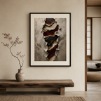 Framed abstract art piece on a wall above a wooden bench with a vase containing branches.
